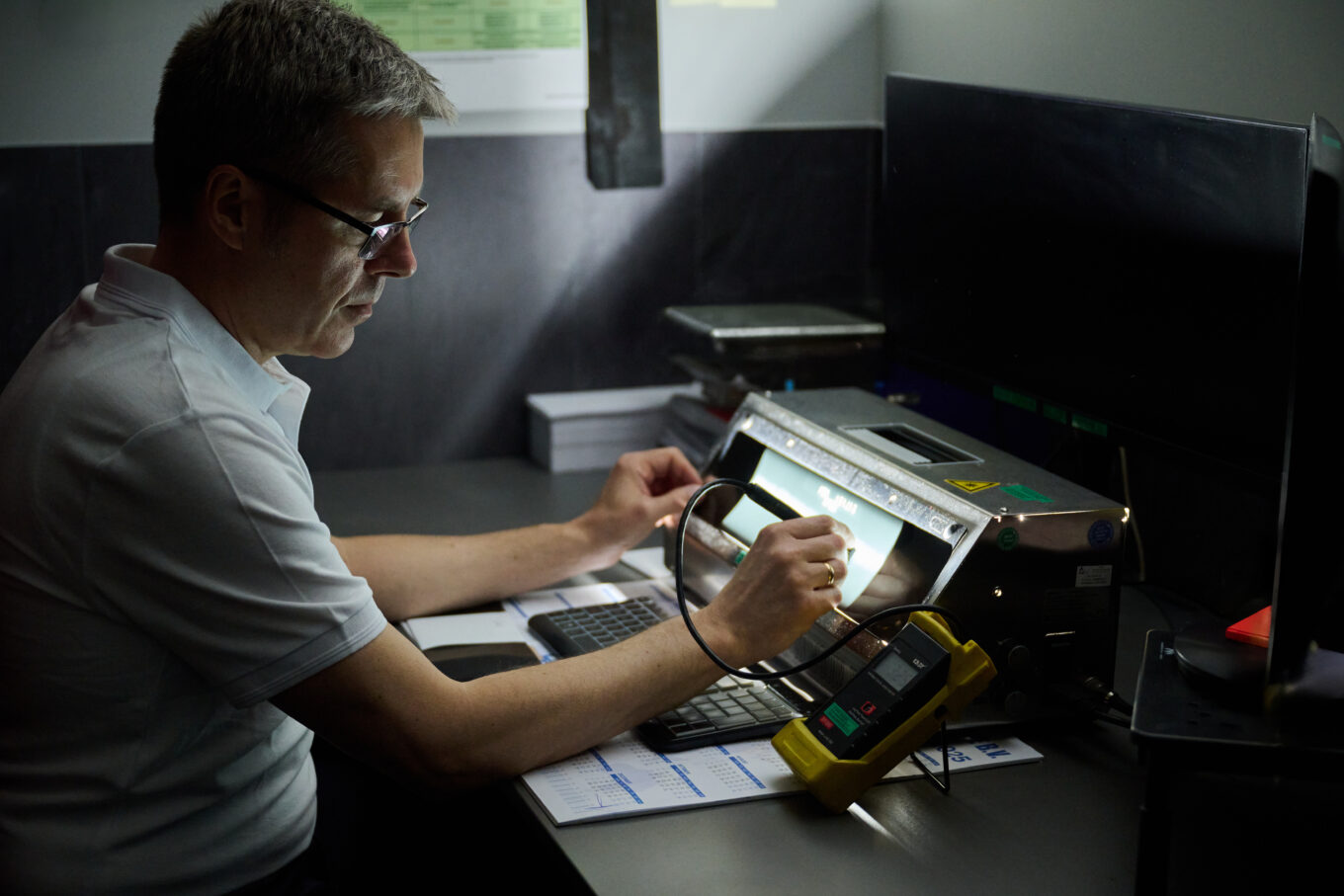 Instruktor NDT w Navi Academy omawia ocenę wyników badania radiograficznego RT przy podświetlanym stanowisku kontrolnym